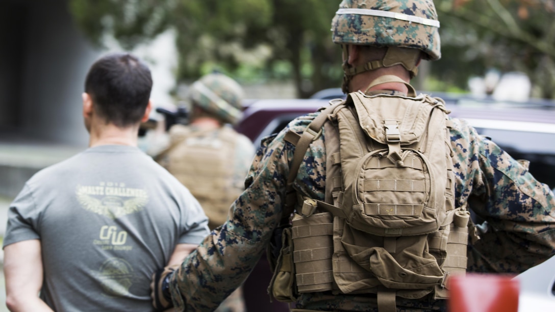 U.S. Marine Corps Lance Cpl. Noah S. Scalish, (right), automatic rifleman, 2nd platoon Bravo Company, 1st Battalion, 8th Marine Regiment, Special-Purpose Marine Air-Ground Task Force-Crisis Response-Africa escorts a simulated suspect during an active shooter exercise at U.S. Embassy, Lisbon, Portugal, Feb. 9, 2016. SPMAGTF-CR-AF conducts a scaled embassy reinforcement exercise at American Embassy Lisbon in coordination with the Regional Security Office and host nation security forces in order to enhance mission essential task proficiency and build relationships. 