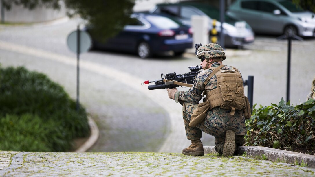 U.S. Marine Corps Lance Cpl. Bradley C. Fryman, rifleman, 2nd platoon Bravo company, 1st Battalion, 8th Marine Regiment, Special-Purpose Marine Air-Ground Task Force-Crisis Response-Africa provides security during an active shooter exercise at U.S. Embassy, Lisbon, Portugal, Feb. 9, 2016. SPMAGTF-CR-AF conducts a scaled embassy reinforcement exercise at American Embassy Lisbon in coordination with the Regional Security Office and host nation security forces in order to enhance mission essential task proficiency and build relationships. 