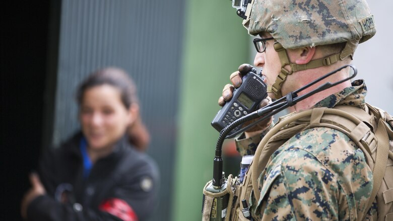 U.S. Marine Corps Cpl. Zeth N. Horr, squad leader, 2nd platoon Bravo Company, 1st Battalion, 8th Marine Regiment, Special-Purpose Marine Air-Ground Task Force-Crisis Response-Africa, radios in for medical assistance for a simulated casualty during an active shooter exercise at U.S. Embassy, Lisbon, Portugal, Feb. 9, 2016. SPMAGTF-CR-AF conducts a scaled embassy reinforcement exercise at American Embassy Lisbon in coordination with the Regional Security Office and host nation security forces in order to enhance mission essential task proficiency and build relationships. 