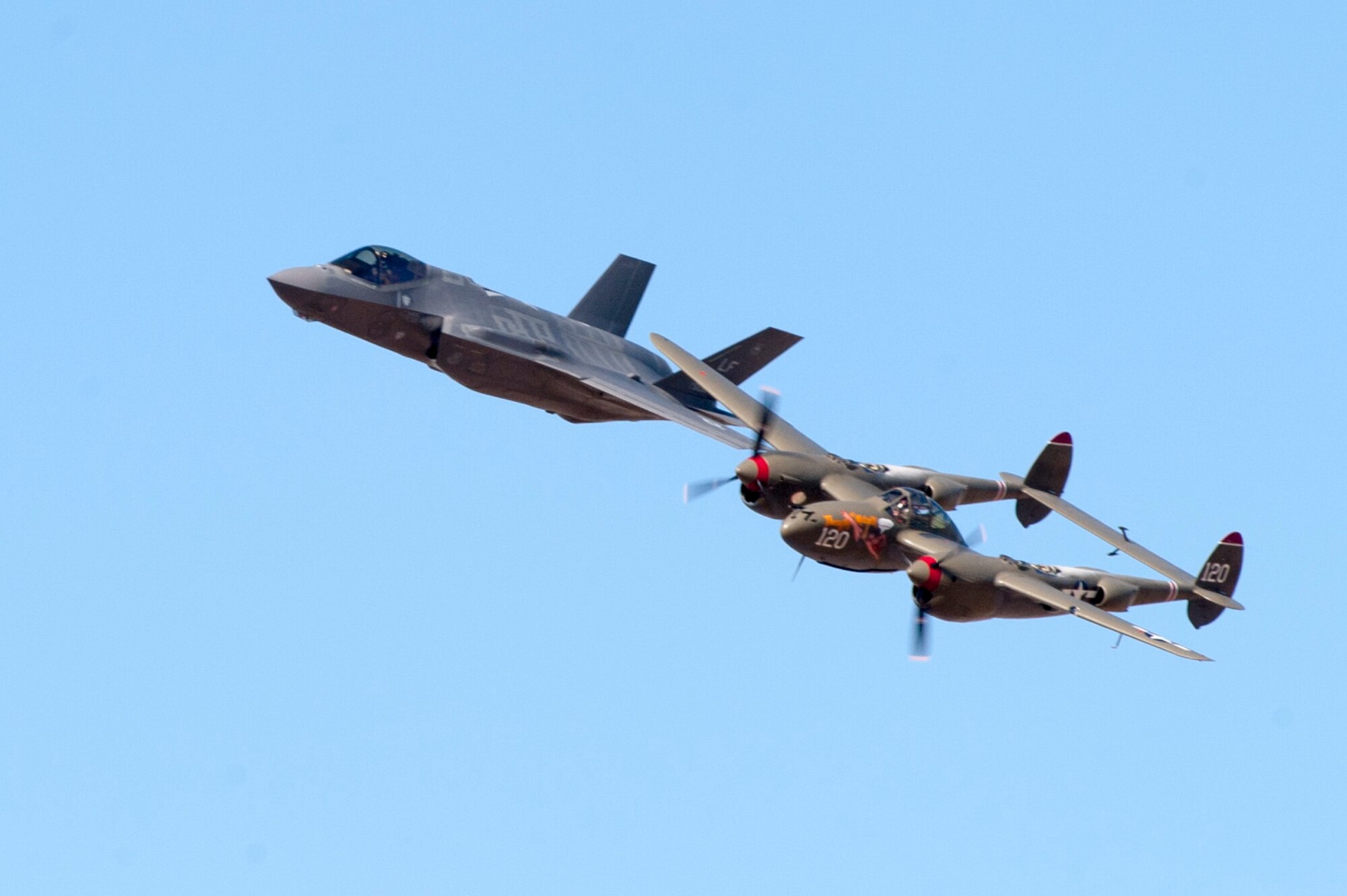 The F-35 Lightning II flies in formation with the P-38 Lightning during the Heritage Flight Conference at Davis Monthan Air Force Base in Tucson, Ariz., March 4-6, 2016.  The  F-35 heritage flight team from Luke Air Force Base, Ariz. is the first F-35 team to participate in the Heritage Flight Program. The program features modern USAF fighter aircraft flying alongside World War II, Korean and Vietnam era aircraft in a dynamic display of our nation's air power history. (U.S. Air Force photo by Staff Sgt. Staci Miller)



