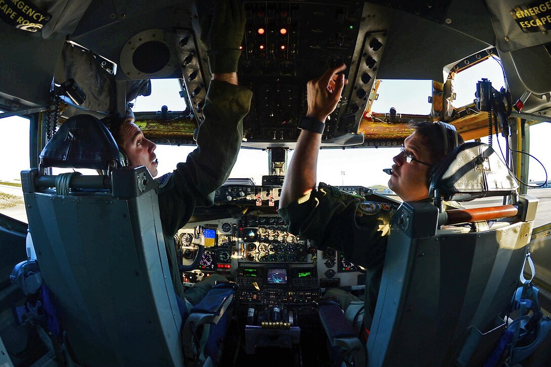 Air Force Capts. Scott Carlan, left, and Jack Ryan inside the cockpit of a KC-135 Stratotanker aircraft prepare to depart Istres-Le Tubé Air Base, France, Feb. 26, 2016. Carlan and Ryan are pilots assigned to the 351st Expeditionary Air Refueling Squadron. Three KC-135 Stratotankers, along with 50 airmen from the 100th Air Refueling Wing, are providing air refueling and airlift support to French operations in Mali and North Africa in support of Operation Juniper Micron. Air Force photo by Senior Airman Erin Trower