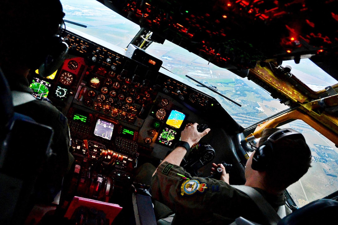 Air Force Capts. Scott Carlan, left, and Jack Ryan fly a KC-135 Stratotanker aircraft during a refueling mission in support of Operation Juniper Micron over France, Feb. 26, 2016. Air Force photo by Senior Airman Erin Trower