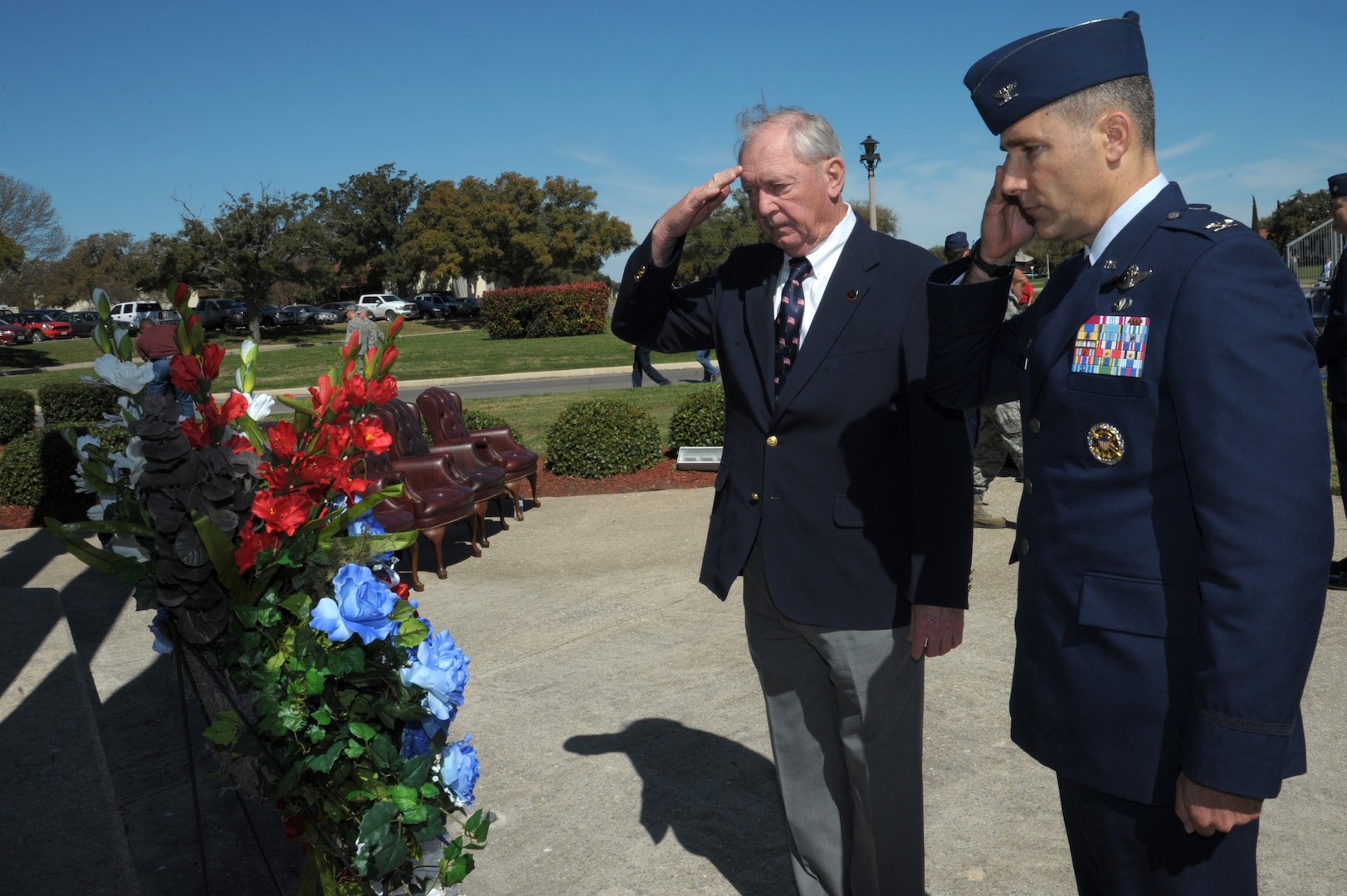 Col. Matthew Isler (right), 12th Flying Training Wing commander, and retired Air Force Col. Robert Certain, salute during the wreath presentation at the Missing Man Monument at Joint Base San Antonio-Randolph, Texas, March 4, 2016.  The wreath-laying ceremony was part of the 43rd annual Freedom Flyer Reunion hosted at the base.