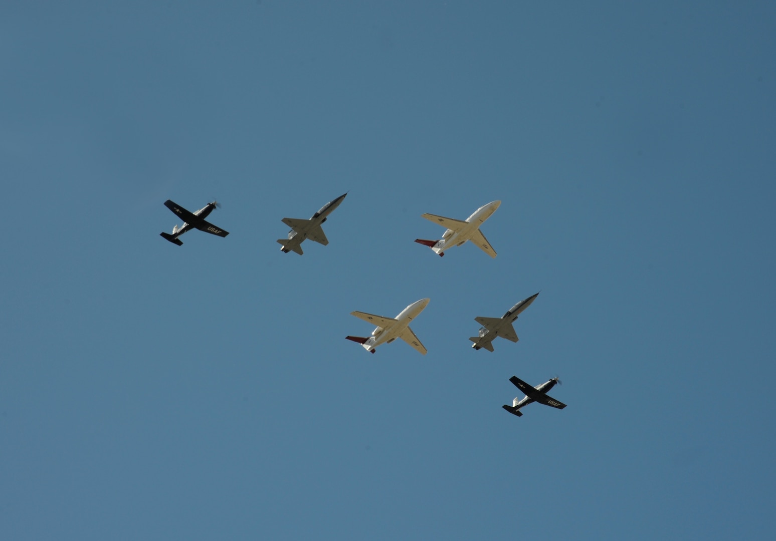 Aircraft assigned to the 12th Flying Training Wing at Joint Base San Antonio-Randolph, Texas, participate a in flyover during the Freedom Flyer Reunion wreath-laying ceremony March 4, 2016.  Flyover aircraft included two T-1 Jayhawks, two T-6 Texan IIs and two T-38C Talons.