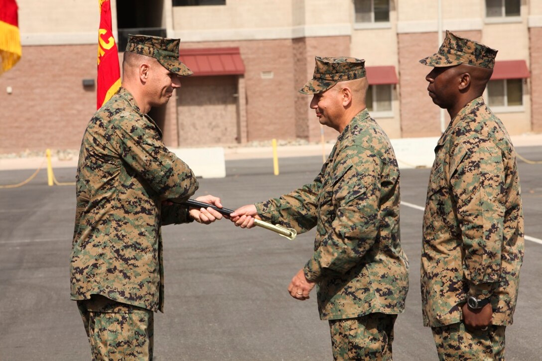 U.S. Marine Col. Vance L. Cryer, left, commanding officer of the 15th Marine Expeditionary Unit, takes the sword of office from Sgt. Maj. Douglas B. Schaefer, right, outgoing sergeant major of the 15th MEU, during a relief and appointment ceremony aboard Camp Pendleton, Calif., Mar. 4, 2016. The 15th MEU's relief and appointment ceremony signifies the passing of responsibility from Sgt. Maj. Douglas B. Schaefer to Sgt. Maj. Dennis K. Campbell. (U.S. Marine Corps photo by Sgt. Jamean R. Berry/Released)