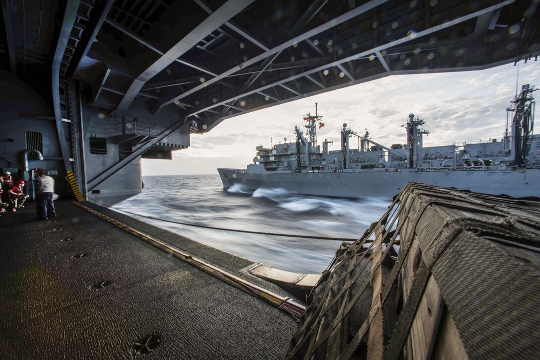 The USS John C. Stennis pulls next to the fast combat support ship USNS Rainier during a replenishment in the South China Sea, March 4, 2016. The Stennis provides a ready force to support security and stability in the Indo-Asia-Pacific region. Navy photo by Petty Officer 3rd Class Kenneth Rodriguez Santiago