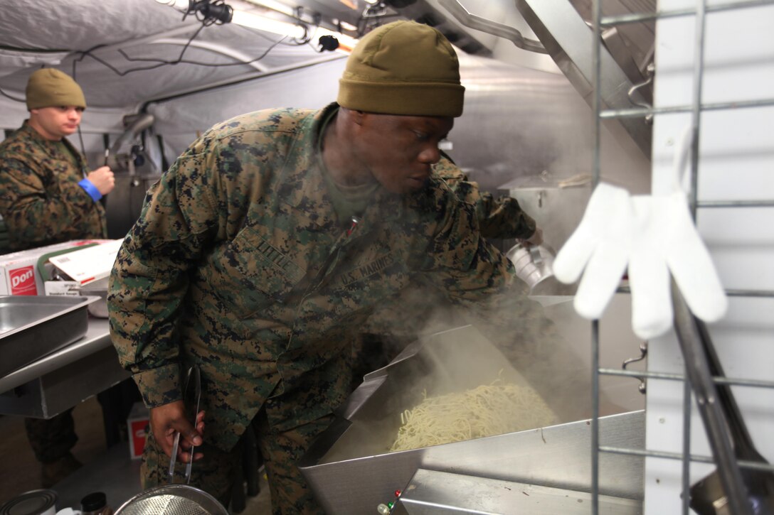 Cpl. Tyrone Little stirs pasta in a field expedient kitchen at Marine Corps Air Station Cherry Point, N.C., Jan. 20, 2016. Food service specialists with Marine Wing Support Squadron 274 compete for the Maj. Gen. William Pendleton Thompson Hill Food Service Award. In a field-like environment, the Marines set up a field expedient kitchen and cooked various entrées in hopes of winning the title of Best Field Mess Award. The Marines were inspected on sanitation, preparation and meal production. Little is a food service specialist with MWSS-274. (U.S. Marine Corps photo by Cpl. Unique Roberts/ Released)