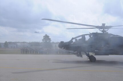 An AH-64 Apache Helicopter, from 1-158th Assault Reconnaissance Battalion (ARB), taxis while soldiers offer their final salute, during a ceremony in Conroe, Texas, to commemorate the final flight of the Apache helicopter in the U.S. Army Reserve, March 6, 2016. 1-158th ARB is a direct reporting unit to the 11th Theater Aviation Command. The 11th Theater Aviation Command (TAC) is the only aviation command in the Army Reserve. (U.S. Army Photo by Capt. Matthew Roman, 11th Theater Aviation Command Public Affairs Officer)