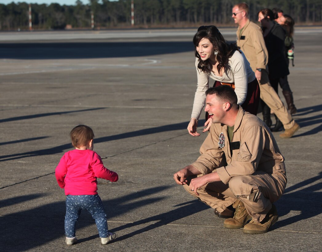 Cpl. Corey Wright and his wife, Brittany Wright, watch as their daughter walks toward them at Marine Corps Air Station Cherry Point, N.C., Jan. 21, 2016. The Marines deployed to Africa and Spain, where they assisted the Personnel Recovery Task Force by working hand-in-hand with other United States military branches. The mission focused on the skills and abilities of service members to successfully reintegrate and recover isolated personnel. On Jan. 13, VMGR-252 welcomed home another detachment, who remained in Moron, Spain. In total the detachment’s Marines moved over 2,900 passengers, 778,000 pounds of cargo and delivered 845,000 pounds of fuel to receiver aircraft. Wright is a fixed-wing aircraft crew chief with VMGR-252. (U.S. Marine Corps photo by Cpl. Unique Roberts/ Released)