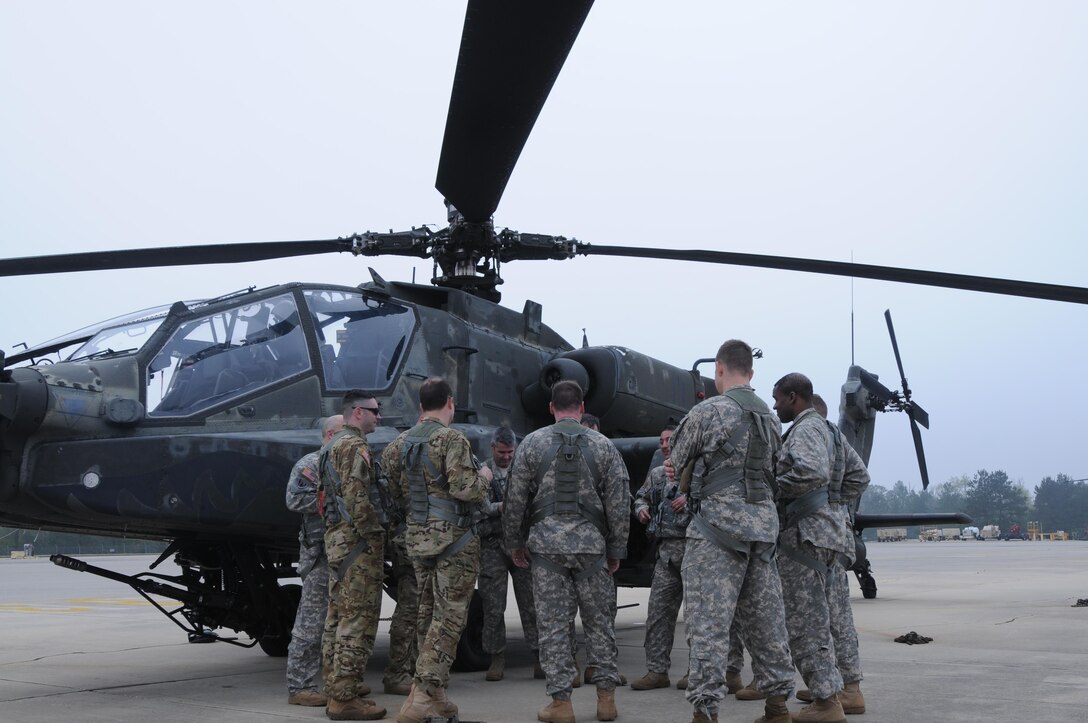 Aviators from 1-158th Assault Reconnaissance Battalion (ARB), conduct a final mission brief in Conroe, Texas, before participating in the last official flight of the AH-64 Apache Helicopter in the U.S. Army Reserve. March 6, 2016. 1-158th ARB is a direct reporting unit to the 11th Theater Aviation Command. The 11th Theater Aviation Command (TAC) is the only aviation command in the Army Reserve. (U.S. Army Photo by Capt. Matthew Roman, 11th Theater Aviation Command Public Affairs Officer)