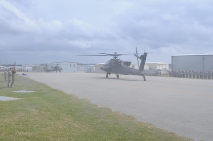 An AH-64 Apache Helicopter, from 1-158th Assault Reconnaissance Battalion (ARB), taxis while soldiers offer their final salute, during a ceremony in Conroe, Texas, to commemorate the final flight of the Apache helicopter in the U.S. Army Reserve, March 6, 2016. 1-158th ARB is a direct reporting unit to the 11th Theater Aviation Command. The 11th Theater Aviation Command (TAC) is the only aviation command in the Army Reserve. (U.S. Army Photo by Capt. Matthew Roman, 11th Theater Aviation Command Public Affairs Officer)