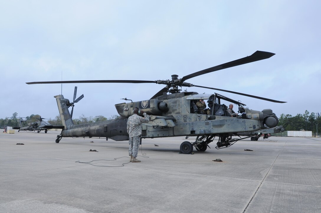 Crew members from 1-158th Assault Reconnaissance Battalion (ARB), conduct final maintenance checks on the AH-64 Apache Helicopter before its ceremonial final flight in Conroe, Texas, March 6, 2016. 1-158th ARB is a direct reporting unit to the 11th Theater Aviation Command. The 11th Theater Aviation Command (TAC) is the only aviation command in the Army Reserve. (U.S. Army Photo by Capt. Matthew Roman, 11th Theater Aviation Command Public Affairs Officer)