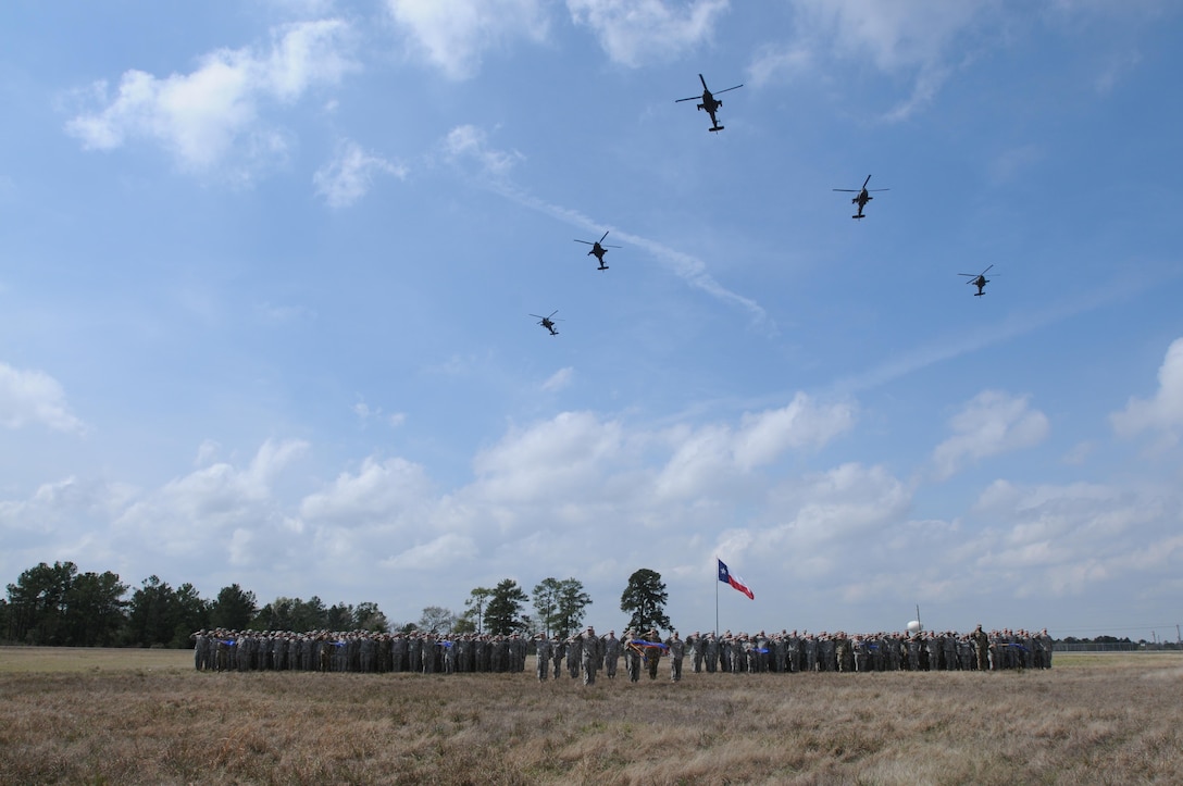 Soldiers from, 1-158th Assault Reconnaissance Battalion (ARB), stand in a battalion formation as five AH-64 Apache Helicopter conduct a ceremonial “fly-over”, in Conroe, Texas, to commemorate the final flight of the Apache helicopter in the U.S. Army Reserve, March 6, 2016. 1-158th ARB is a direct reporting unit to the 11th Theater Aviation Command. The 11th Theater Aviation Command (TAC) is the only aviation command in the Army Reserve. (U.S. Army Photo by Capt. Matthew Roman, 11th Theater Aviation Command Public Affairs Officer)
