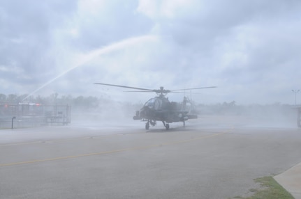 An AH-64 Apache Helicopter, from 1-158th Assault Reconnaissance Battalion (ARB), taxis under fire hoses during a ceremony in Conroe, Texas, to commemorate the final flight of the Apache helicopter in the U.S. Army Reserve, March 6, 2016. 1-158th ARB is a direct reporting unit to the 11th Theater Aviation Command. The 11th Theater Aviation Command (TAC) is the only aviation command in the Army Reserve. (U.S. Army Photo by Capt. Matthew Roman, 11th Theater Aviation Command Public Affairs Officer)