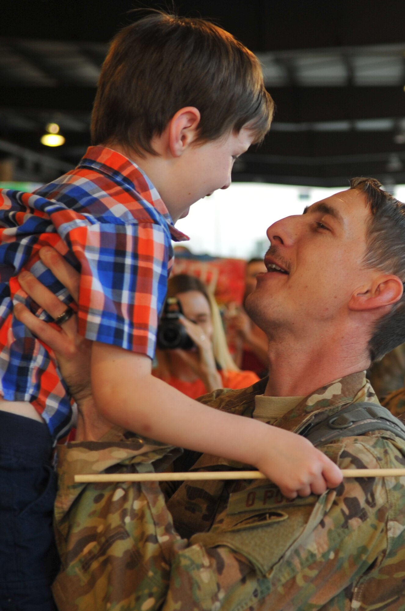 Staff Sgt. Robert I. McLendon, sheet metal technician with the 1st Special Operations Maintenance Squadron, is welcomed home by his son during Operation Homecoming at Hurlburt Field, Fla., March 6, 2016. Operation Homecoming welcomed home McLendon and other Air Commandos from their overseas deployment. (U.S. Air Force photo by Airman 1st Class Joseph Pick)