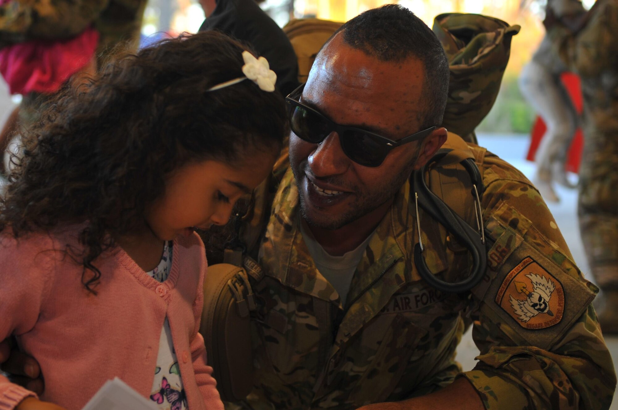 Tech. Sgt. Michael A. Jones, loadmaster with the 1st Special Operations Support Squadron, greets his daughter during Operation Homecoming at Hurlburt Field, Fla., March 6, 2016. Jones, along with other Air Commandos, returned home from an overseas deployment. (U.S. Air Force photo by Airman 1st Class Joseph Pick)