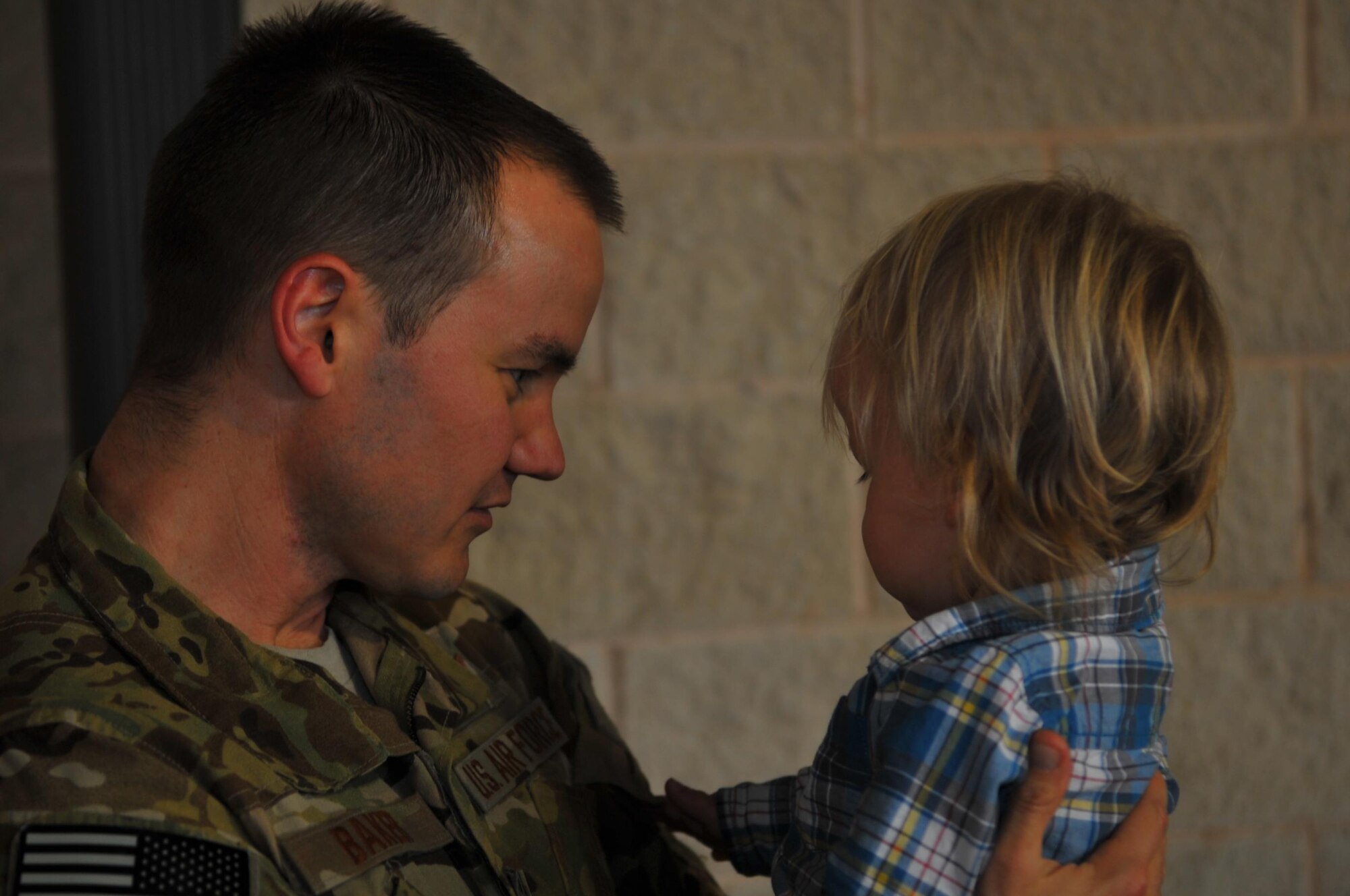 Maj. Jacoby L. Baker, weapons and tactics strike chief with Air Force Special Operation Command, greets his son during Operation Homecoming at Hurlburt Field, Fla., March 6, 2016. Operation Homecoming welcomed home Baker and other Air Commandos from their overseas deployment. (U.S. Air Force photo by Airman 1st Class Joseph Pick)