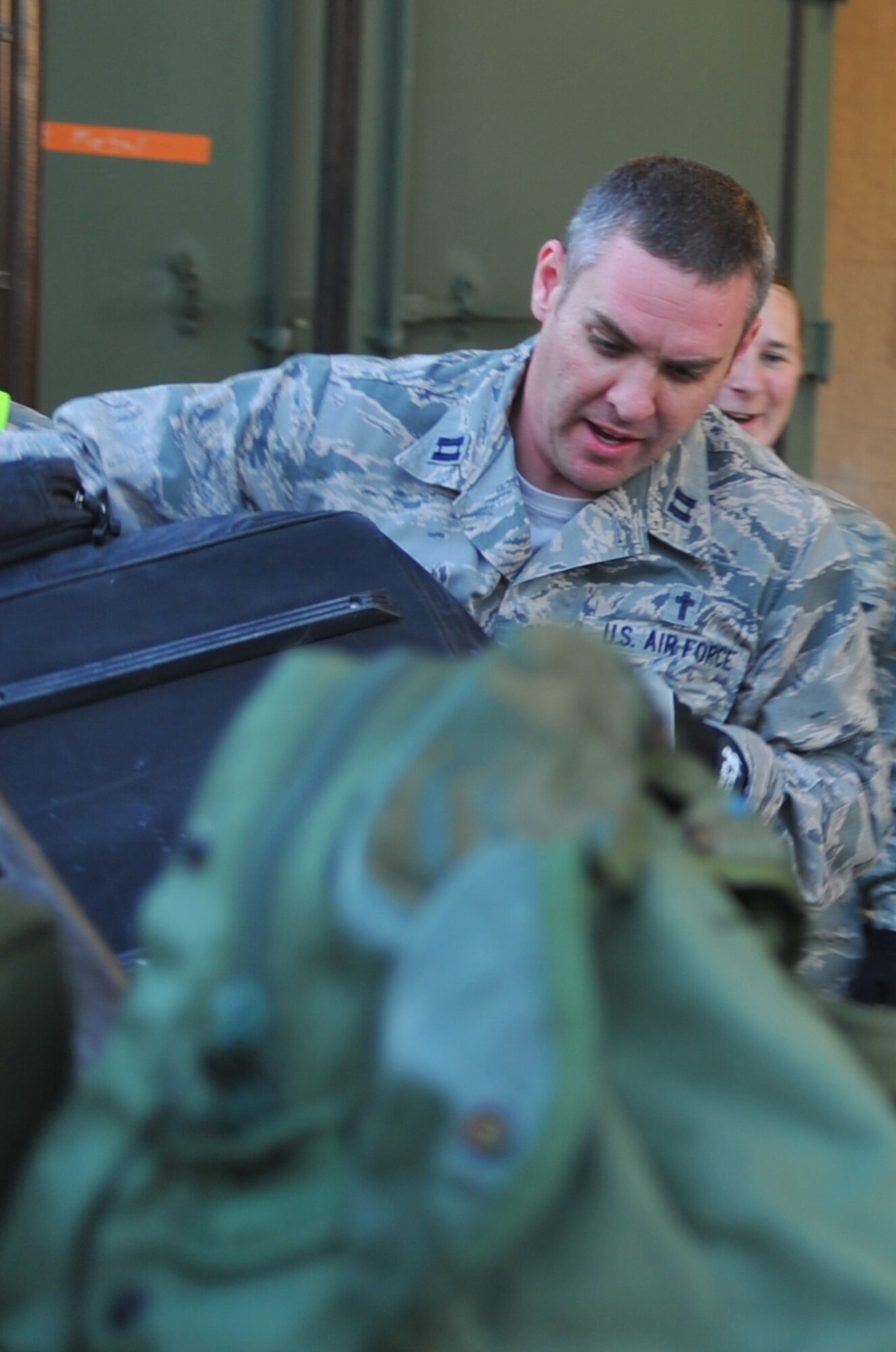 Chaplain (Capt.) Doug Lumpkin, with the 1st Special Operations Wing chaplain’s office, helps unload returning Air Commandos' bags during Operation Homecoming at Hurlburt Field, Fla., March 6, 2016. Lumpkin and other Airmen volunteered to retrieve the bags of the Air Commandos returning from their overseas deployment. (U.S. Air Force photo by Airman 1st Class Joseph Pick)