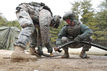 U.S. Army Spc. Orlando Espinoza and Spc. Ryan Canfield of the 301st Quartermaster Company (QM Company) establish connections between potable water holding bags at the Brindle Lake training area on Joint Base McGuire-Dix-Lakehurst, N.J., March 6, 2016. Soldiers of the 301st QM Company produce and provide potable water to Soldiers training during Combat Support Training Exercise 78-16-01.