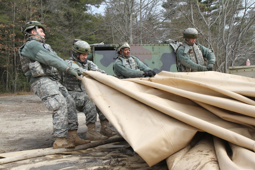 U.S. Army Soldiers of the 431st Quartermaster Company (QM Company) drain a potable water holding bag in preparation for storage at the Brindle Lake training area on Joint Base McGuire-Dix-Lakehurst, N.J., March 6, 2016. Soldiers of the 431st QM Company provide potable water to Soldiers training during Combat Support Training Exercise 78-16-01.