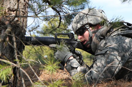 U.S. Army Spc. John Curtin of the 957th Quartermaster Company (QM Co.) engages notional insurgents during a simulated attack on Joint Base McGuire-Dix-Lakehurst, N.J., March 6, 2016. Soldiers of the 957th QM Company are participating in Combat Support Training Exercise 78-16-01 to improve unit readiness.