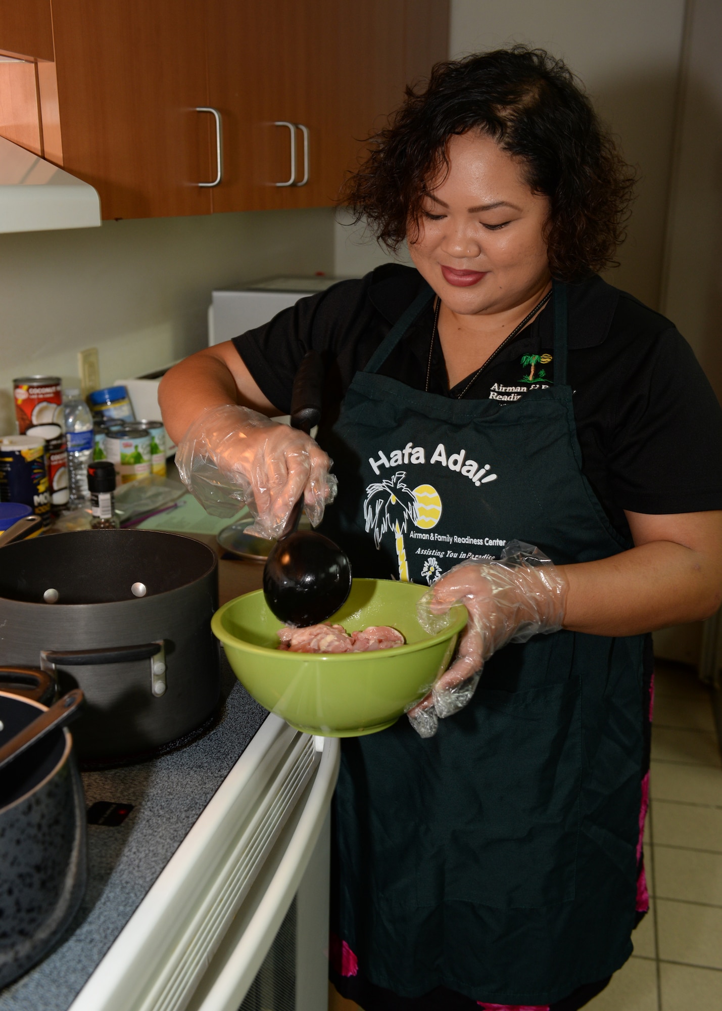 Hope Cortez, 36th Force Support Squadron Airman and Family Readiness Center work life consultant, prepares a dish during a Chamorro History Month cooking demonstration March 4, 2016, at Andersen Air Force Base, Guam. Throughout the month of March, the A&FRC will be hosting a variety of classes and activities surrounding local culture, customs and traditions. (U.S. Air Force photo/Senior Airman Cierra Presentado)