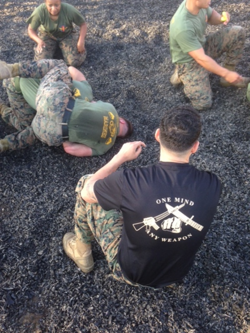 Sergeant Robles of 1st TSB, a Martial Arts Instructor, observes proper techniques are applied and tap out procedures are followed.