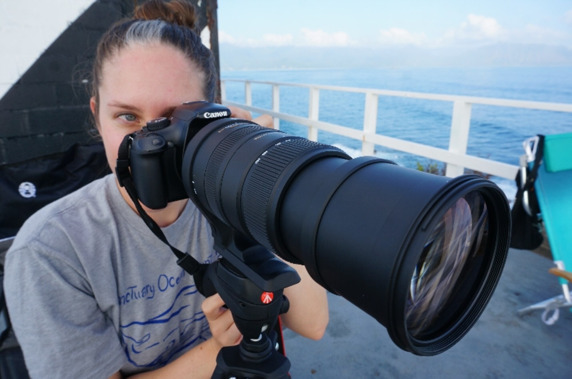 Capt. Natalie Chounet, Sanctuary Ocean Count Site Leader, zooms in through her telephoto lens after spotting a whale spout on the horizon. Chounet is searching for humpback whales from atop Marine Corps Base Hawaii's Pyramid Rock Feb. 27, 2016. The Sanctuary Ocean Count project is sponsored by the National Oceanic and Atmospheric Administration to provide scientists with data documenting the humpback whales’ annual 2,500-mile, round-trip migration from Alaska to the Hawaiian Islands. Chounet is the Installation Management Support Center Det. 2 Basing and Beddown Flight’s deputy chief. The detachment is located at Joint Base Pearl Harbor-Hickam, Hawaii. (U.S. Air Force Photo by Senior Master Sgt. Denise Johnson/Released)