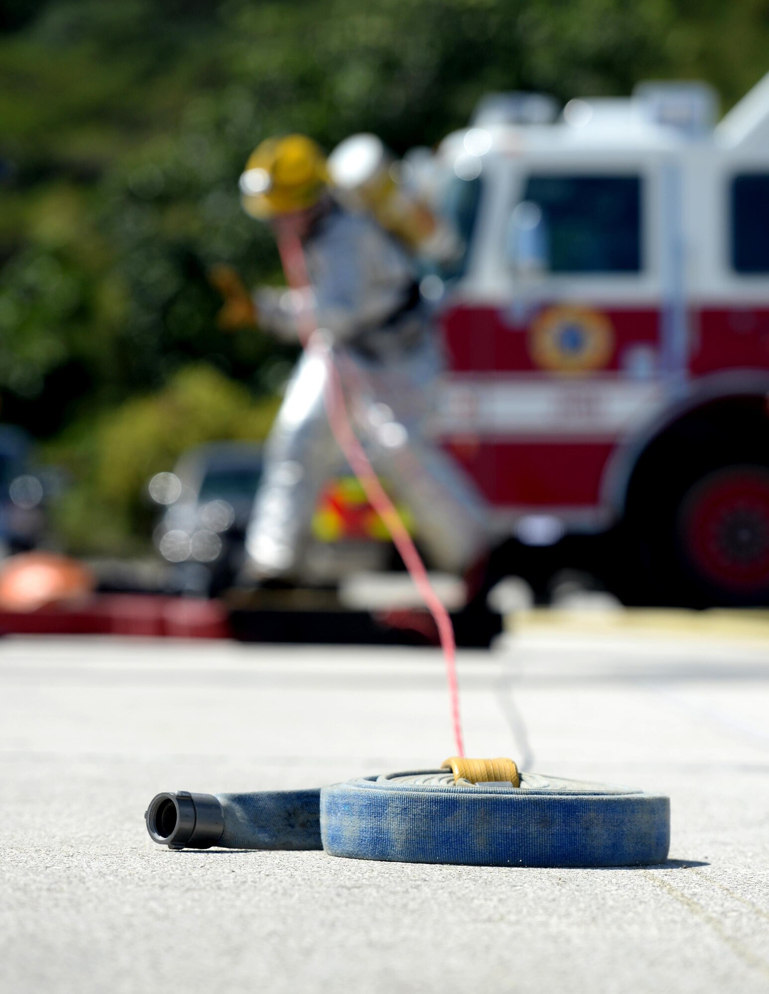 Staff Sgt. Anthony Whitney, 36th Civil Engineer Squadron fire protection crew chief, pulls a fire hose during the annual Guam Fire Muster competition March 5, 2016, in Hagåtña, Guam. The competition included firefighting teams from the Guam Airport Fire Rescue, Guam Fire Department, Naval Base Guam Fire Department, Saipan Airport aircraft rescue and Andersen Air Force Base. (U.S. Air Force photo/Staff Sgt. Benjamin Gonsier)