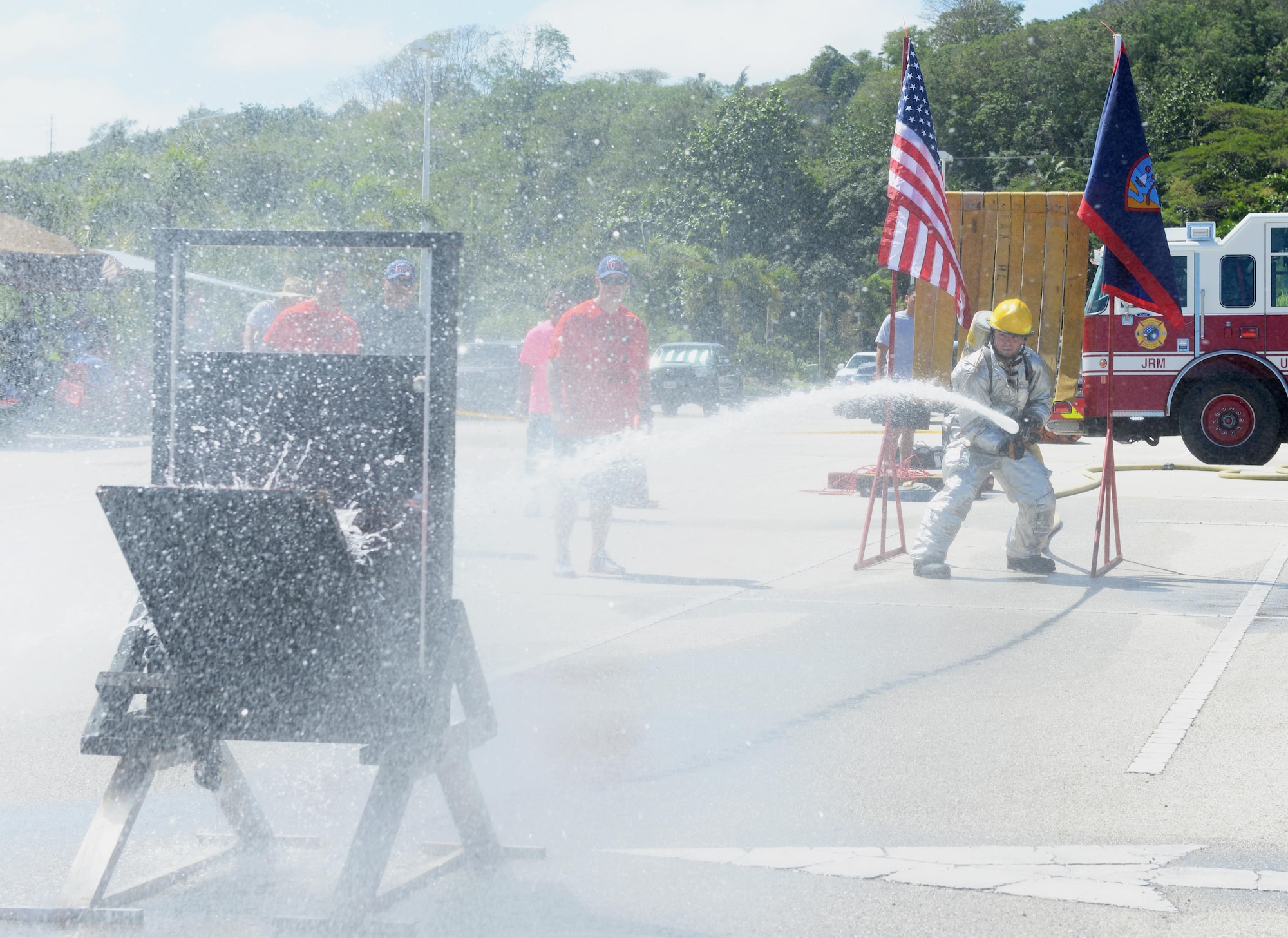 Airman 1st Class Zach Hamlette, 36th Civil Engineer Squadron fire protection crew chief, sprays water at a target during the annual Guam Fire Muster competition March 5, 2016, in Hagåtña, Guam. During this obstacle course competition, Hamlette aimed and sprayed water at a target simulating a fire. Once the target was hit, he was able to proceed to the next obstacle. (U.S. Air Force photo/Staff Sgt. Benjamin Gonsier)