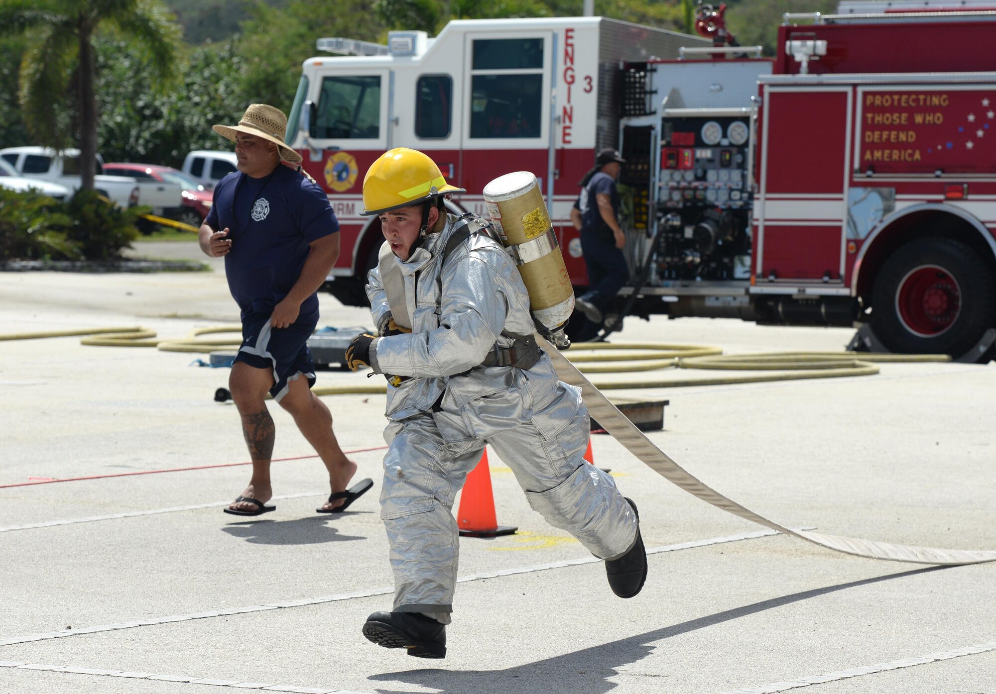 Airman 1st Class Jared May, 36th Civil Engineer Squadron fire protection crew chief, sprints with a hose during the annual Guam Fire Muster competition March 5, 2016, in Hagåtña, Guam. The fire muster tests a firefighter’s ability to perform basic firefighting techniques to include spraying a target with water, navigating through obstacles, carrying a casualty and using a sledgehammer. (U.S. Air Force photo/Staff Sgt. Benjamin Gonsier)