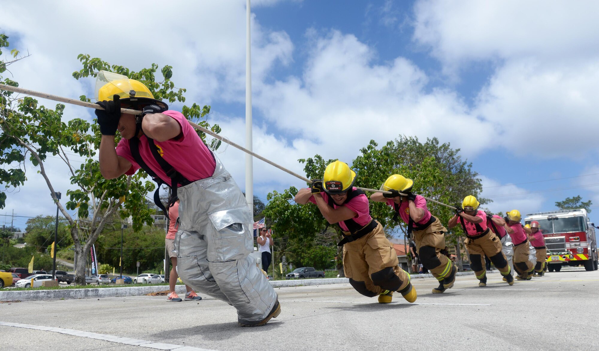 Firefighters from the Saipan Airport aircraft rescue pull a fire truck during the annual Guam Fire Muster competition March 5, 2016, in Hagåtña, Guam. The Saipan Airport aircraft rescue firefighting team travelled more than 100 miles to compete in the 2016 Guam Fire Muster, which also marked the first time Saipan participated in the event. (U.S. Air Force photo/Staff Sgt. Benjamin Gonsier)