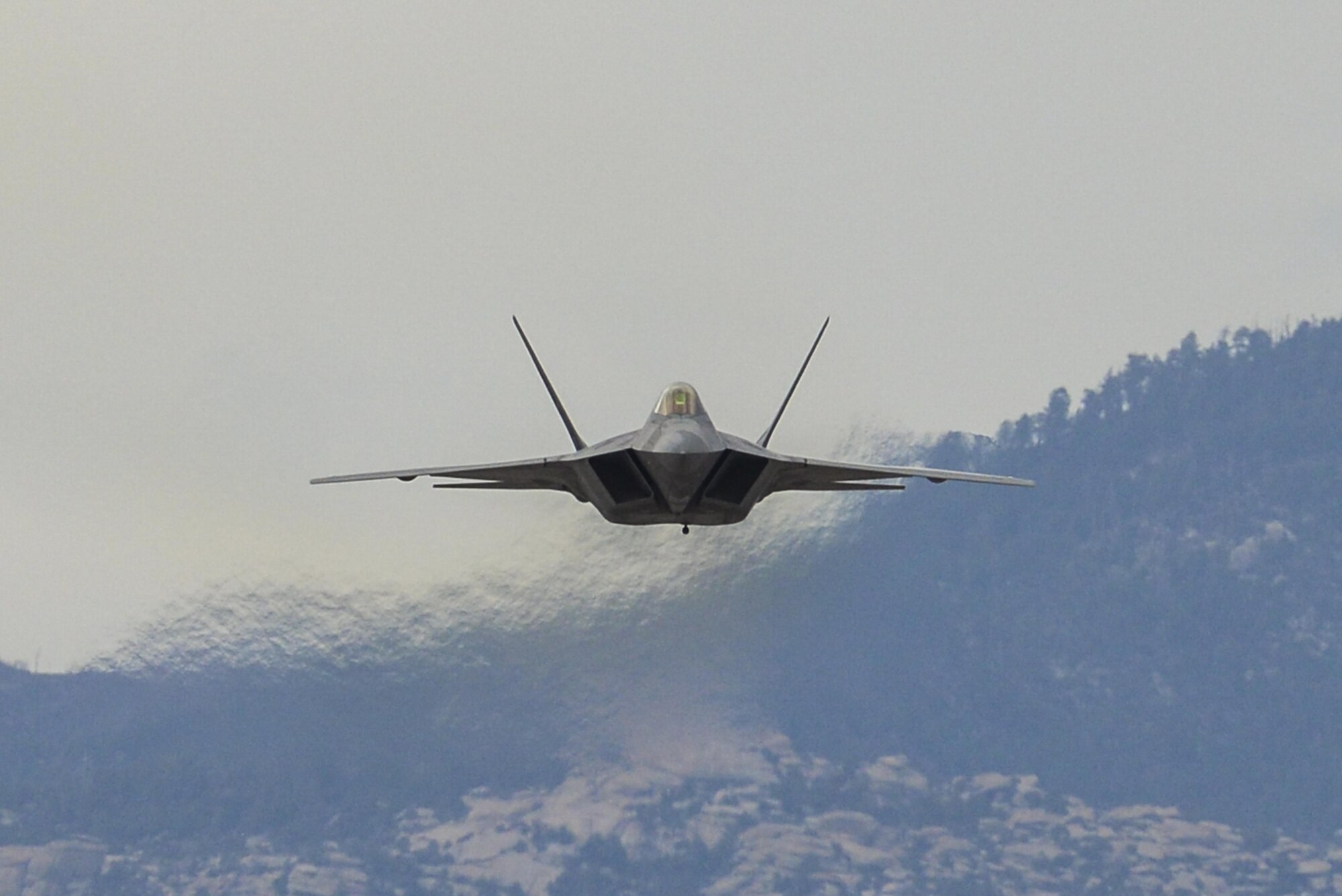 A U.S. Air Force F-22 Raptor performs an aerial maneuver during the 2016 Heritage Flight Training and Certification Course at Davis-Mothan Air Force Base, Ariz., March 5, 2016.  The annual aerial demonstration training event has been held at D-M since 2001, and the course features aerial demonstrations from historical and modern fighter aircraft. (U.S. Air Force photo by Senior Airman Chris Massey/Released)