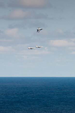 160307-N-MY174-021 PHILIPPINE SEA (March 7, 2016) - An F/A-18E Super Hornet flown by Cmdr. Douglas Peterson breaks formation, turning over the Warhawks of Strike Fighter Squadron (VFA) 97 to Cmdr. Matthew Doyle during an aerial change of command ceremony above USS John C. Stennis (CVN 74). Providing a ready force supporting security and stability in the Indo-Asia-Pacific, Stennis is operating as part of the Great Green Fleet on a regularly scheduled 7th Fleet deployment. (U.S. Navy photo by Mass Communication Specialist Seaman Tomas Compian/ Released)