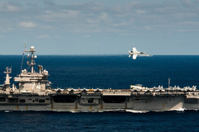 160307-N-MY174-030 PHILIPPINE SEA (March 7, 2016) - An F/A-18E Super Hornet assigned to the Warhawks of Strike Fighter Squadron (VFA) 97 performs a flyby during an aerial change of command ceremony above USS John C. Stennis (CVN 74). Providing a ready force supporting security and stability in the Indo-Asia-Pacific, Stennis is operating as part of the Great Green Fleet on a regularly scheduled 7th Fleet deployment. (U.S. Navy photo by Mass Communication Specialist Seaman Tomas Compian/ Released)