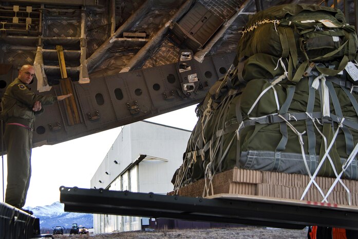 160302-F-XA488-051A JOINT BASE ELMENDORF-RICHARDSON (Mar. 2, 2016) Air Force Master Sgt. Cecil Dickerson marshals a forklift onto the cargo ramp on Joint Base Elmendorf-Richardson, Alaska, March 2, 2016, in support of Ice Exercise 2016 in the Arctic Ocean Dickerson is a loadmaster assigned to the 249th Airlift Squadron, and is supporting the U.S. Navy submarine forces during Ice Exercise 2016 in the Arctic Ocean. (U.S. Air Force photo by Staff Sgt. Sheila DeVera/Released)