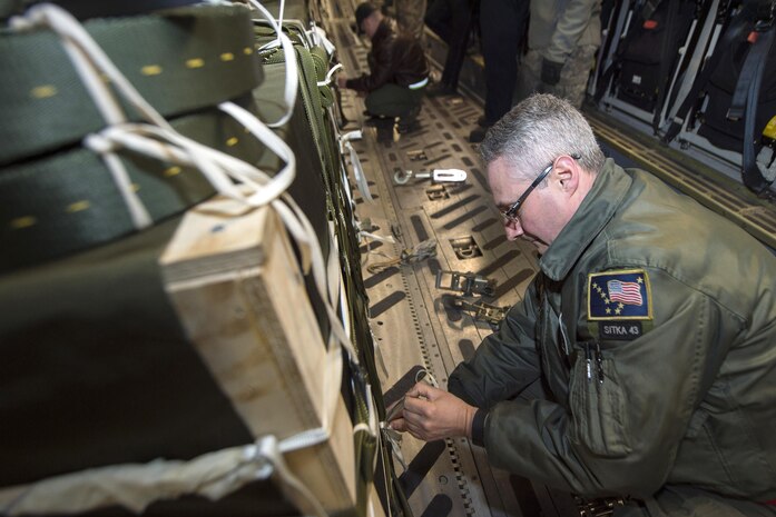 160302-F-XA488-101A JOINT BASE ELMENDORF-RICHARDSON (Mar. 2, 2016) Air Force Senior Master Sgt. Jeffrey Watson prepares to set up a release gate before taking off from Joint Base Elmendorf-Richardson, Alaska, March 2, 2016, in support of Ice Exercise 2016 in the Arctic Ocean. Watson is a senior enlisted manager assigned to the 249th Airlift Squadron. (U.S. Air Force photo by Staff Sgt. Sheila DeVera/Released)