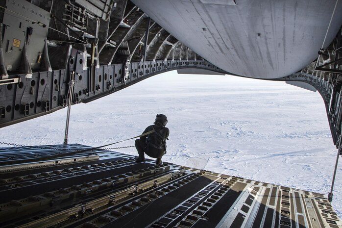 160302-F-XA488-230A ARCTIC OCEAN (Mar. 2, 2016) Air Force Tech. Sgt. Dough Mathes looks out over a drop zone after delivering 12,000 pounds of cargo from a C-17 Globemaster III aircraft in the Arctic Ocean in support of the U.S. Navy Ice Exercise 2016, March 2, 2016. Mathes is a loadmaster assigned to the 249th Airlift Squadron. (U.S. Air Force photo by Staff Sgt. Sheila DeVera/Released)