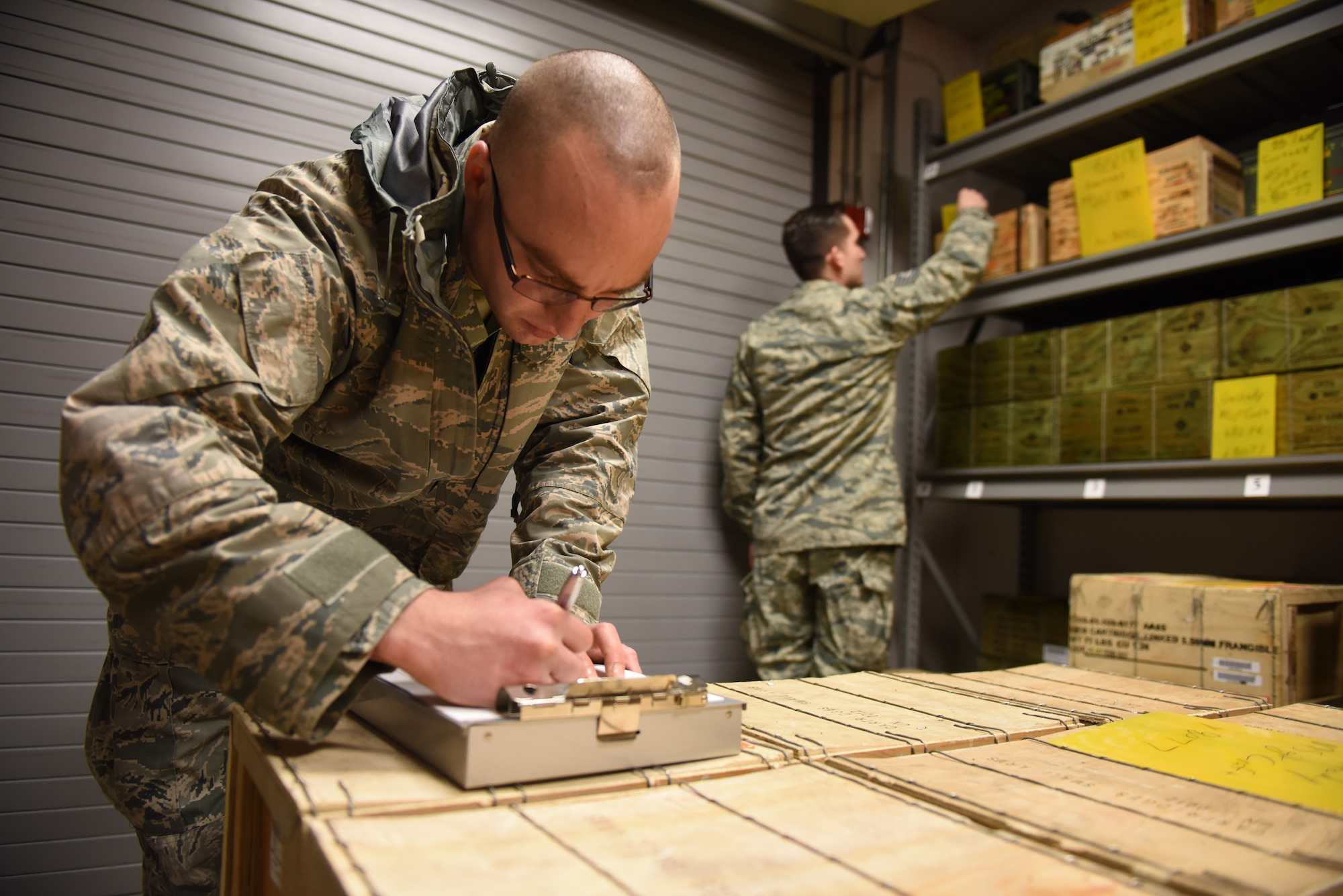 Staff Sgt. Matthew Hohe, quality assurance inspector of the munitions flight with the 911th Maintenance Squadron, inventories munitions with the help of his coworker Tech. Sgt. William Fedorek, munitions inspector of the munitions flight, at the Pittsburgh International Air Reserve Station, Pennsylvania, March 3, 2016. Munitions inventory is done in pairs rather than alone to ensure accuracy. (U.S. Air Force photo by Airman Bethany Feenstra)