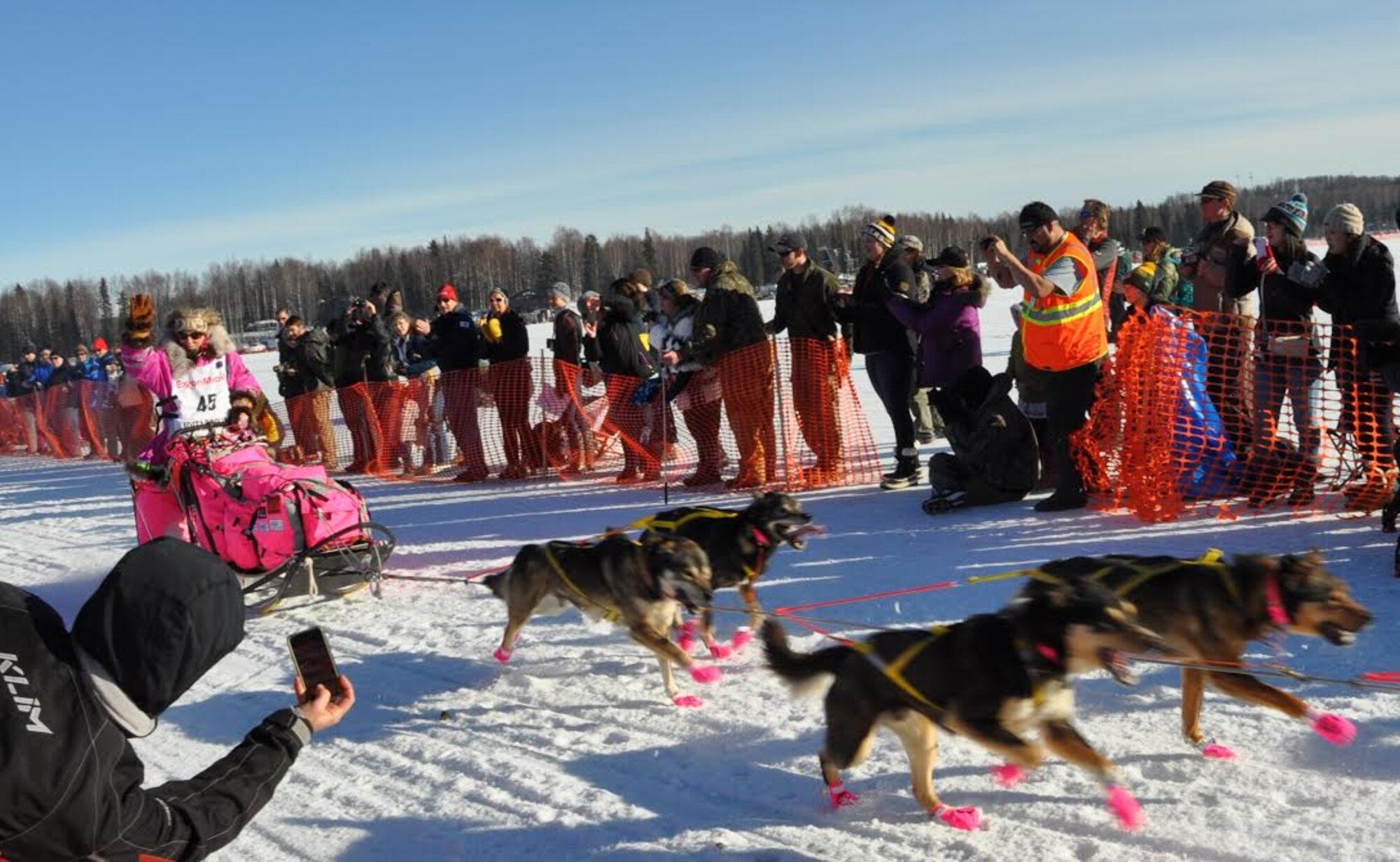DeeDee Jonrowe from Willow, Alaska, whose father was an Army veteran at JBER, is cheered on by fans as she starts her race at the Iditarod restart in Willow, March 6, 2016. The Iditarod is a 1,000-mile sled dog race across the rugged terrain of Alaska. This is the second year Air Force Reserve Recruiting has sponsored the Iditarod, known as “The Last Great Race on Earth.”(U.S. Air Force/Tech. Sgt. Kimberly Rae Moore)