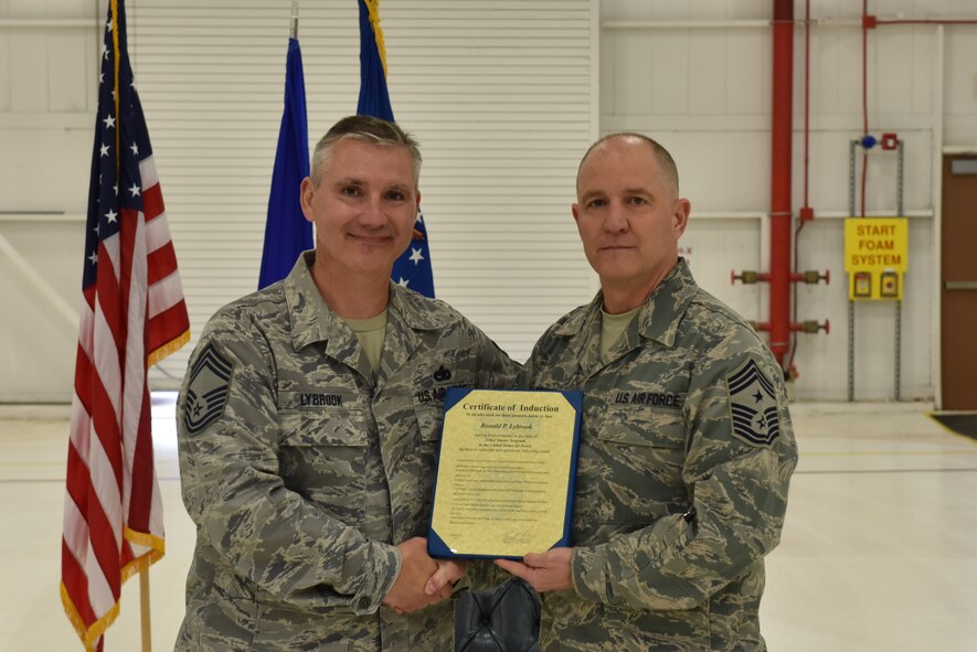 Chief Master Sgt. Ronald Lybrook, chief of the 911th Aircraft Maintenance Squadron, accepts a Certificate of Induction during a chief induction ceremony at the Pittsburgh International Airport Air Reserve Station, March 5, 2016. The ceremony took place in front of 911th AMXS Airmen and Lybrook’s friends and family. (U.S. Air Force photo by Senior Airman Marjorie A. Bowlden)
