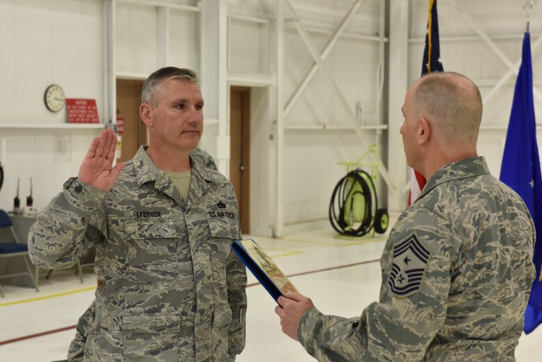 Chief Master Sgt. Ronald Lybrook, chief of the 911th Aircraft Maintenance Squadron, accepts the chief master sergeant’s creed during a chief induction ceremony at the Pittsburgh International Airport Air Reserve Station, March 5, 2016. The ceremony took place in front of 911th AMXS Airmen and Lybrook’s friends and family. (U.S. Air Force photo by Senior Airman Marjorie A. Bowlden)