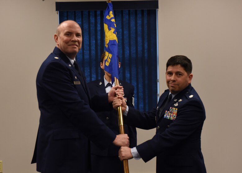 Lt. Col. James Klein, commander of the 911th Mission Support Group, passes the 32nd Aerial Port Squadron guidon to incoming commander, Lt. Col. Reginald G. Trujillo, Jr., during an assumption of command ceremony at the Pittsburgh International Airport Air Reserve Station, March 3, 2016. The assumption of command ceremony marked a formal passing of responsibility, authority, and accountability of the 32nd APS’s command. (U.S. Air Force photo by Staff Sgt. Jonathan Hehnly)