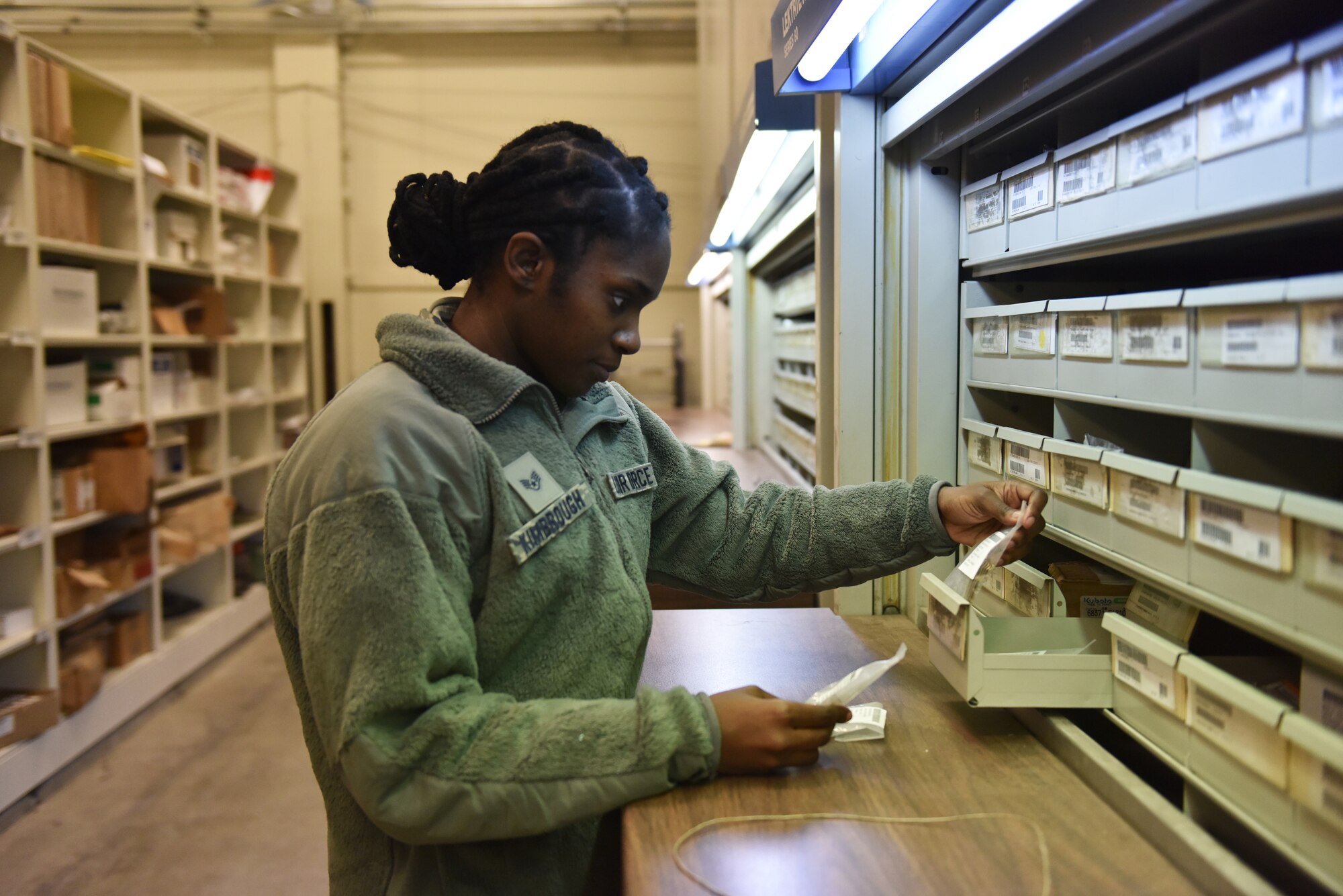 Staff Sgt. Dakia Kimbrough, logistics supply manager with the 911th Logistics Readiness Squadron, checks and organizes items at a LRS warehouse here, March 6, 2016. Kimbrough, a member of the 911th AW since 2012, has a strong passion for her role in supporting the mission. (U.S. Air Force photo by Senior Airman Marjorie A. Bowlden)