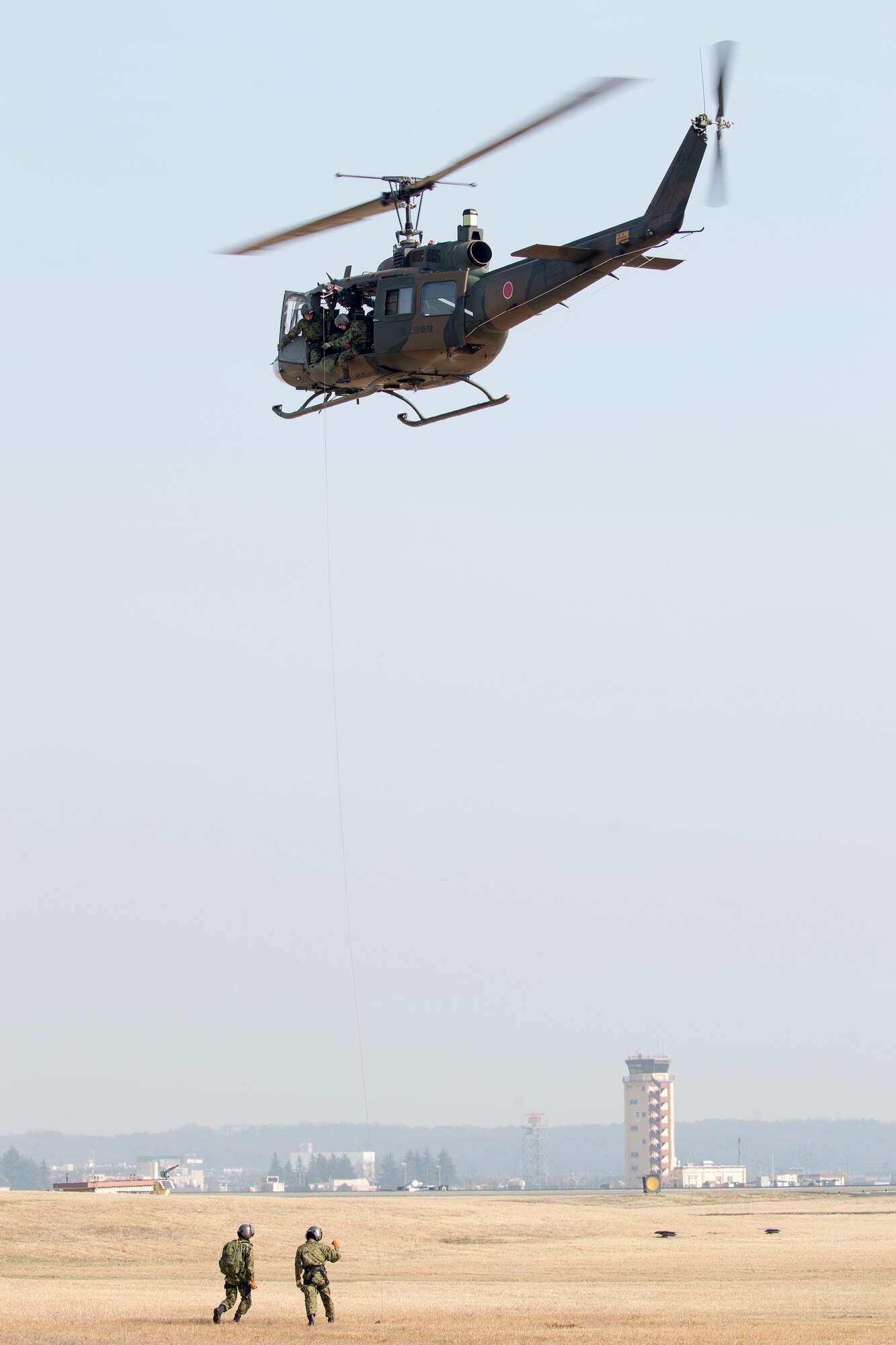 Japan Ground Self-Defense Force members with the Eastern Army Helicopter, 1st Aviation perform a hoist demonstration at Yokota Air Force, Japan, March 4, 2016.  JGSDF members demonstrated their hoist capabilities to 459th Airlift Squadron members. (U.S. Air Force photo by Osakabe Yasuo/Released)