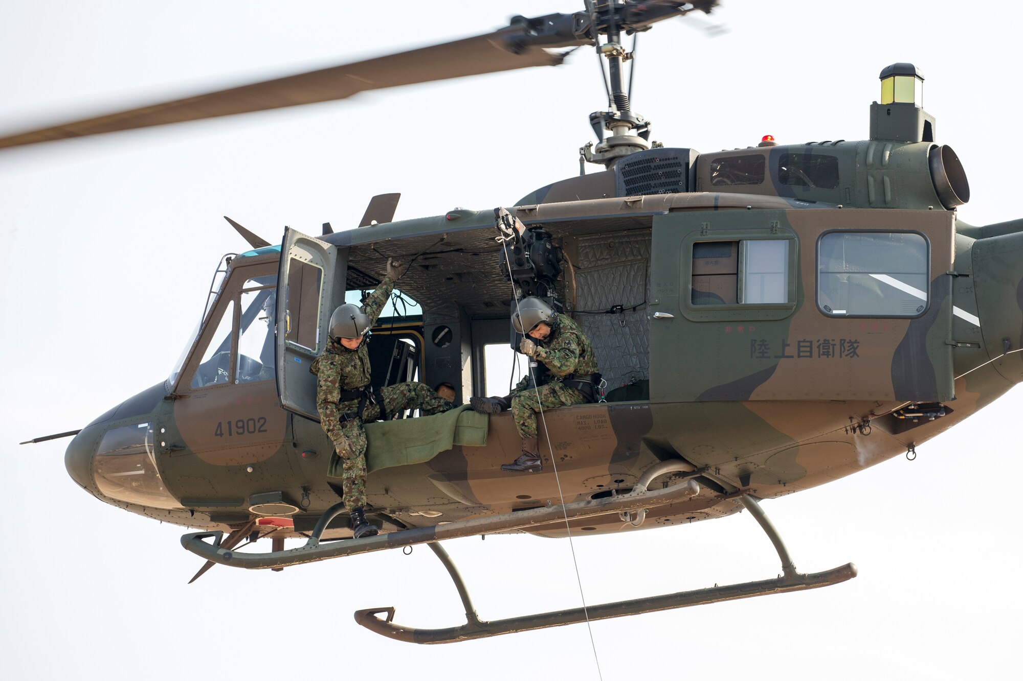Japan Ground Self-Defense Force members with the Eastern Army Helicopter, 1st Aviation perform a hoist demonstration at Yokota Air Force, Japan, March 4, 2016.  JGSDF members demonstrated their hoist capabilities to 459th Airlift Squadron members. (U.S. Air Force photo by Osakabe Yasuo/Released)