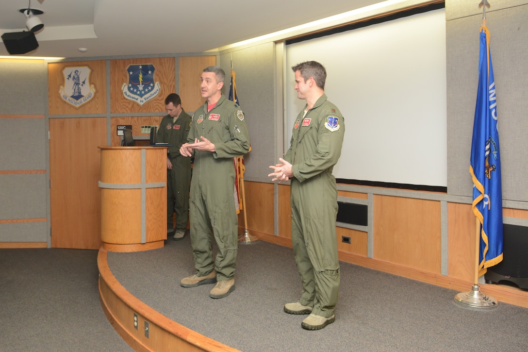 Col. Jon Kalberer, 176th Fighter Squadron commander, speaks about the accomplishments of Maj. Adam Kinzinger, 115th Fighter Wing RC-26 Metroliner pilot, prior to awarding him The Meritorious Service Medal during a ceremony at Truax Field, Madison, Wis., March 5, 2016. Kinzinger received the award for various mission accomplishments including 420 million dollars of drug-related seizures, more than 700 arrests of high-value drug traffickers, and two deployments in support of overseas contingency operations where he executed over 275 combat flight hours and 100 combat sorties. (U.S. Air National Guard photo by Staff Sgt. Andrea F. Rhode)