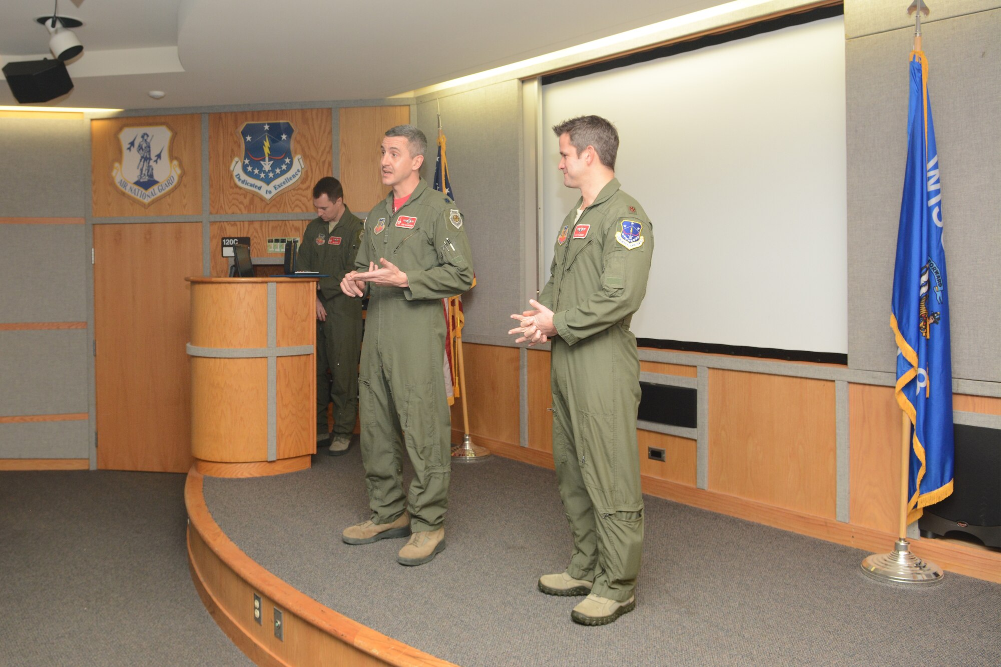 Col. Jon Kalberer, 176th Fighter Squadron commander, speaks about the accomplishments of Maj. Adam Kinzinger, 115th Fighter Wing RC-26 Metroliner pilot, prior to awarding him The Meritorious Service Medal during a ceremony at Truax Field, Madison, Wis., March 5, 2016. Kinzinger received the award for various mission accomplishments including 420 million dollars of drug-related seizures, more than 700 arrests of high-value drug traffickers, and two deployments in support of overseas contingency operations where he executed over 275 combat flight hours and 100 combat sorties. (U.S. Air National Guard photo by Staff Sgt. Andrea F. Rhode)