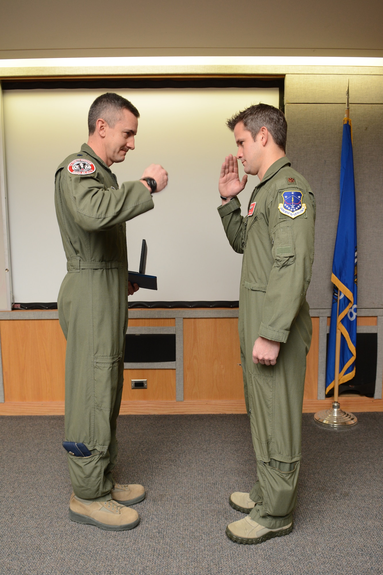 Maj. Adam Kinzinger, 115th Fighter Wing RC-26 Metroliner pilot, salutes Col. Jon Kalberer, 176th Fighter Squadron commander, after he receives The Meritorious Service Medal during a ceremony at Truax Field, Madison, Wis., March 5, 2016. Kinzinger received the award for various mission accomplishments including 420 million dollars of drug-related seizures, more than 700 arrests of high-value drug traffickers, and two deployments in support of overseas contingency operations where he executed over 275 combat flight hours and 100 combat sorties. (U.S. Air National Guard photo by Staff Sgt. Andrea F. Rhode)
