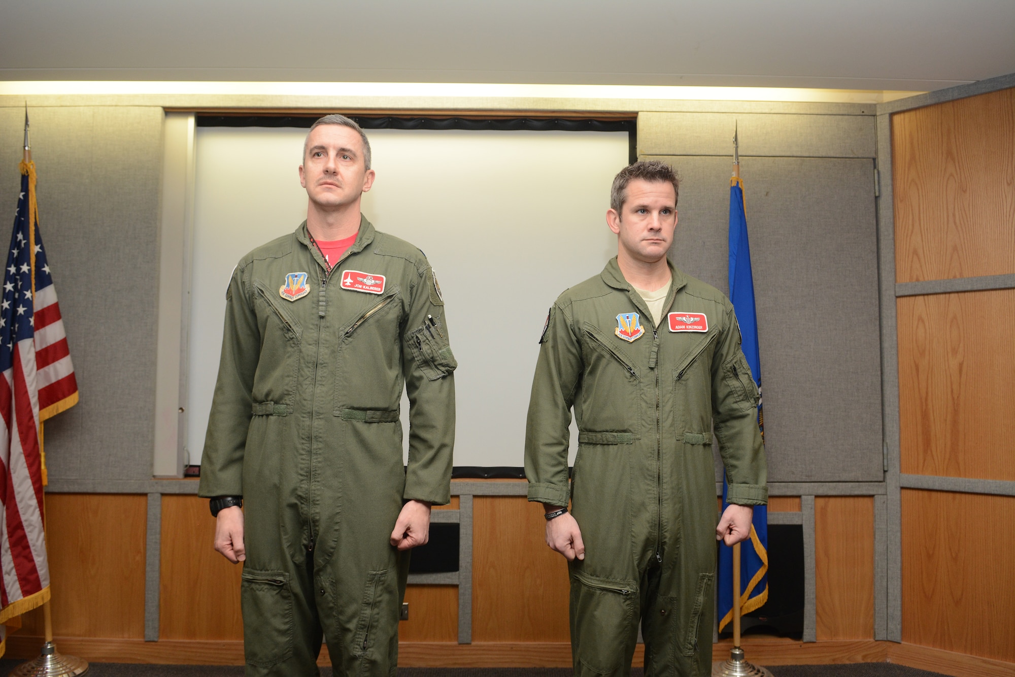 Maj. Adam Kinzinger, 115th Fighter Wing RC-26 Metroliner pilot, stands beside Col. Jon Kalberer, 176th Fighter Squadron commander, as The Meritorious Service Medal award package is read during a ceremony at Truax Field, Madison, Wis., March 5, 2016. Kinzinger received the award for various mission accomplishments including 420 million dollars of drug-related seizures, more than 700 arrests of high-value drug traffickers, and two deployments in support of overseas contingency operations where he executed over 275 combat flight hours and 100 combat sorties. (U.S. Air National Guard photo by Staff Sgt. Andrea F. Rhode)
